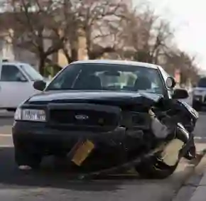 Damaged vehicle after a collision, with visible dents and shattered glass, for a section focusing on car accident claims.