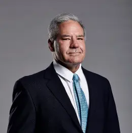 Professional headshot of Steve Garner wearing business attire, against a plain grey background.