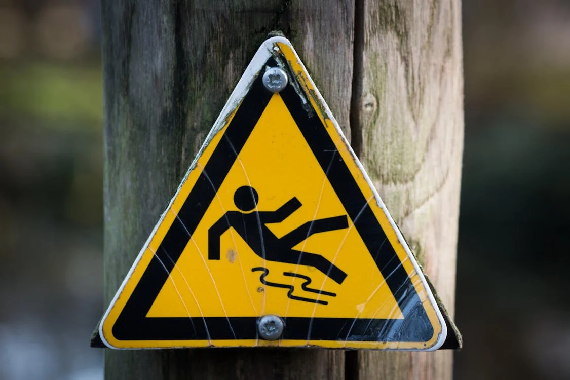 Slip and fall sign posted on a wood piller