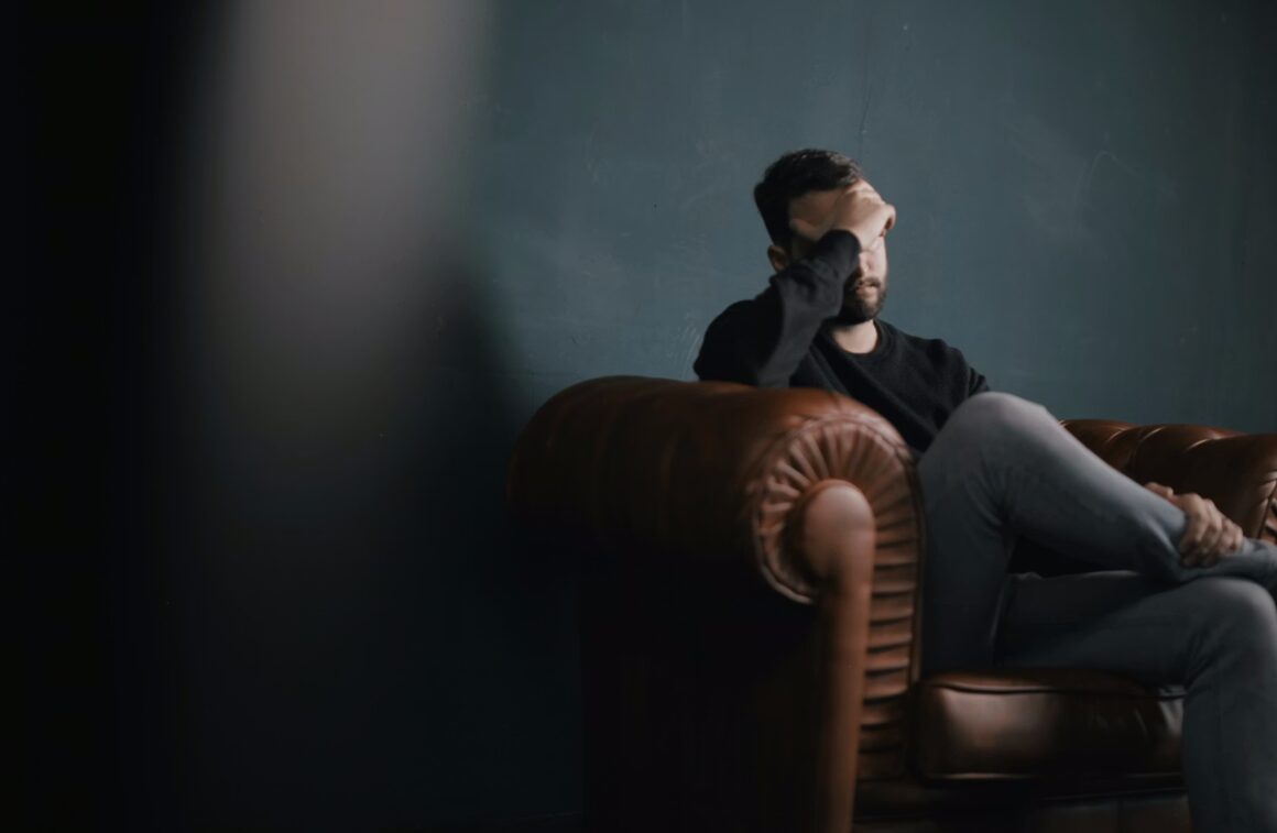 man in chair looking upset