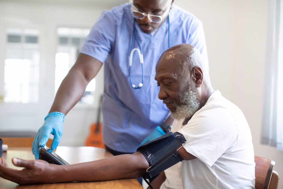 man getting his blood pressure taken by a doctor